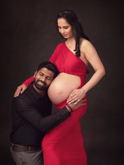 A hug for both mom and baby. This pose beautifully illustrates the father's connection to both his partner and his unborn child.