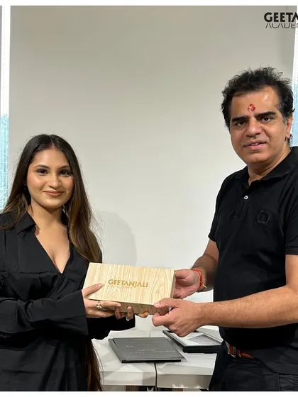 Our founder presents a special award to a graduate, recognizing her outstanding performance and dedication during her time at the academy.