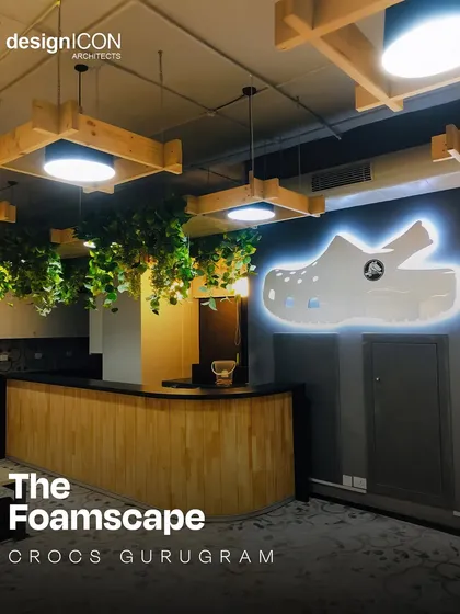 The reception at the Crocs headquarters in Gurugram, which we named 'The Foamscape'. We brought the brand's playful identity to life with a custom illuminated logo, suspended greenery, and warm wood finishes, creating a space that is both fun and functional.