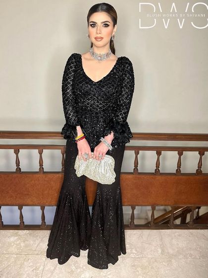 A full-length shot of the client holding a clutch, her high ponytail completing the glamorous evening ensemble.