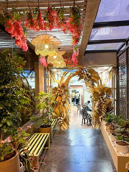 Another view of the enchanting entrance at Organic Creamery. The combination of living plants, dried florals, and warm lighting creates a multi-sensory experience that is both beautiful and memorable.