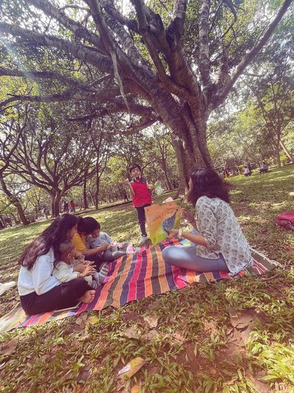 A child stands up, fully engaged, while I read from a colorful book. It's this freedom of movement and expression that we encourage, allowing kids to experience stories in a way that feels natural to them.