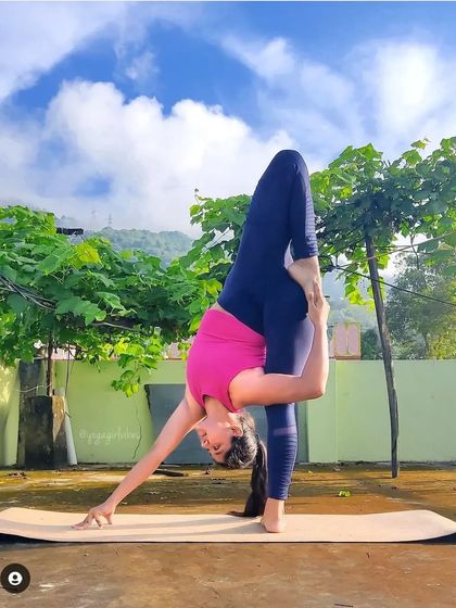 This advanced balancing pose, a variation of Bird of Paradise, requires incredible hamstring flexibility and core control to stay upright.