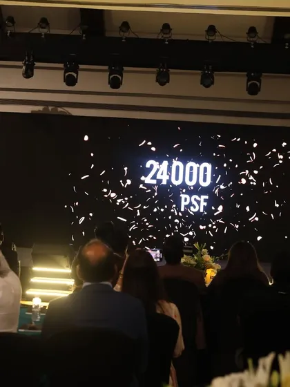 The final moment of a magical price reveal for a real estate project. The number '24000 PSF' is displayed on the giant LED screen amidst a celebratory burst, creating a high impact, memorable conclusion to the presentation for Great Value Realty.