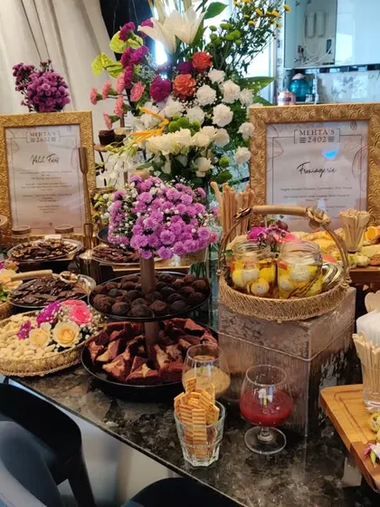 An abundant grazing table for a housewarming soiree, featuring a mix of artisanal chocolates, Indian mithais, cheeses, and fresh fruits. This spread was just the beginning of the evening's celebrations.