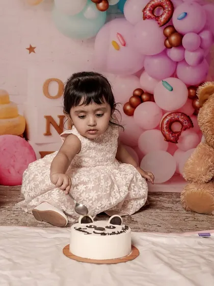 A first birthday is a huge milestone, and a cake smash session is the perfect way to celebrate. I set up this adorable balloon backdrop and let the birthday girl have her first taste of cake, capturing her pure, messy joy.