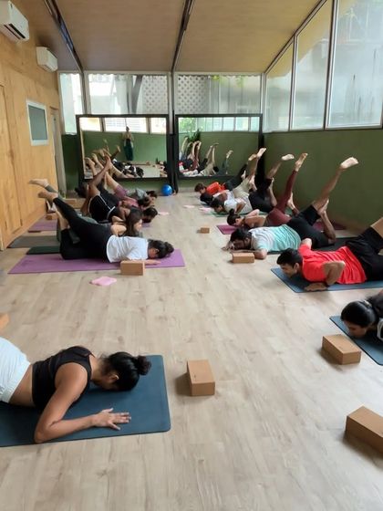 A class works on a one-legged locust pose variation, building back strength and flexibility in unison.