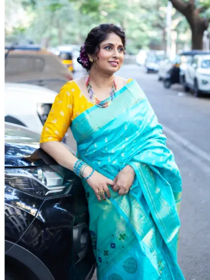 Taking the saree outdoors changes everything. This bright turquoise Paithani looks so fresh and modern against the urban backdrop. It shows how versatile a traditional saree can be for lifestyle and brand photography.