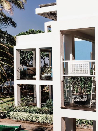 This image showcases how we integrate greenery into modern architecture. Plants are strategically placed on multiple balconies and levels, making the entire building feel alive and connected to nature.