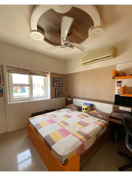 Another child's bedroom design, this one using a combination of orange and brown with a unique wooden ceiling feature. The design is playful yet can adapt as the child grows.