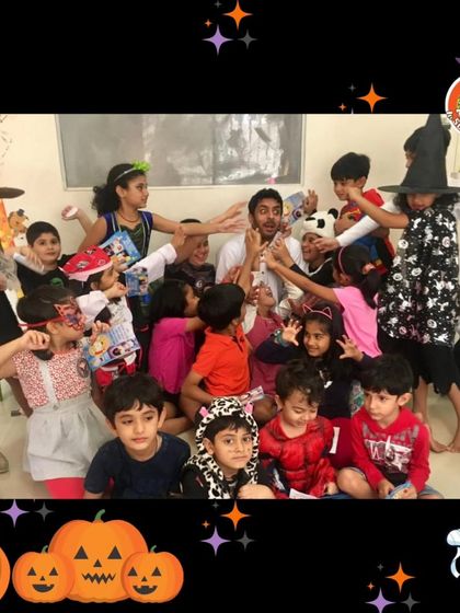 A group of little monsters, witches, and superheroes mobbing one of our professors. Our Halloween parties are joyfully chaotic and full of laughter.