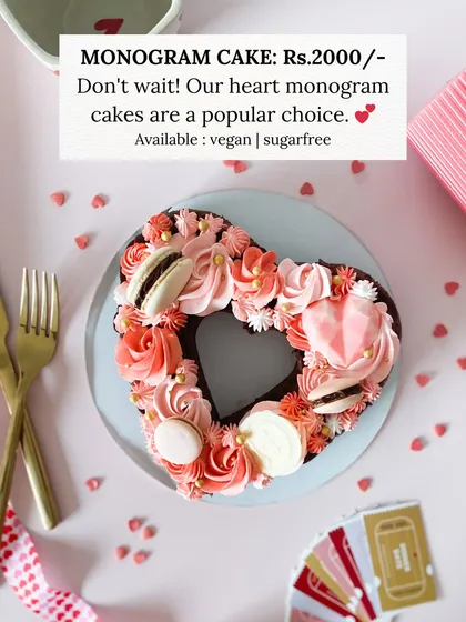 Our heart monogram cakes are a popular choice for a reason. This one, with its beautiful piping and macarons, is available in vegan and sugar-free options.