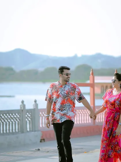 A casual walking shot by the lake, with the couple in fun, matching floral prints. This shows a different, more relaxed side of a Jaipur pre-wedding shoot.