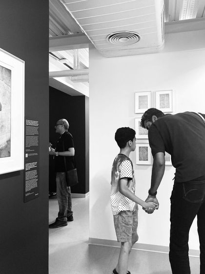 A father and son exploring an exhibit at the Museum of Art and Photography (MAP). We designed the museum to be accessible and engaging for all ages, a place for families to discover art together.