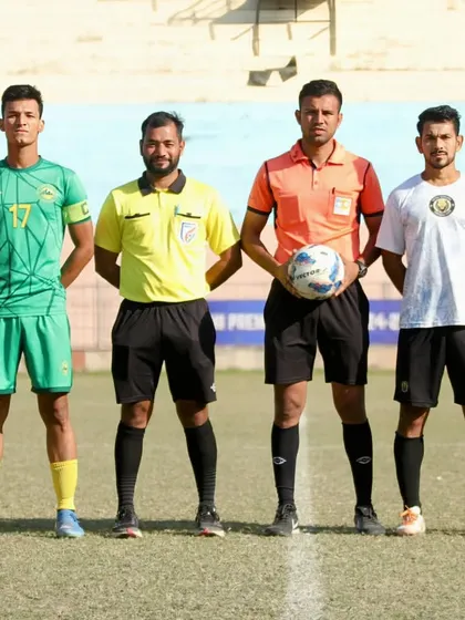 The captains meet with the match officials before kick-off. A moment of respect and sportsmanship before the battle begins.