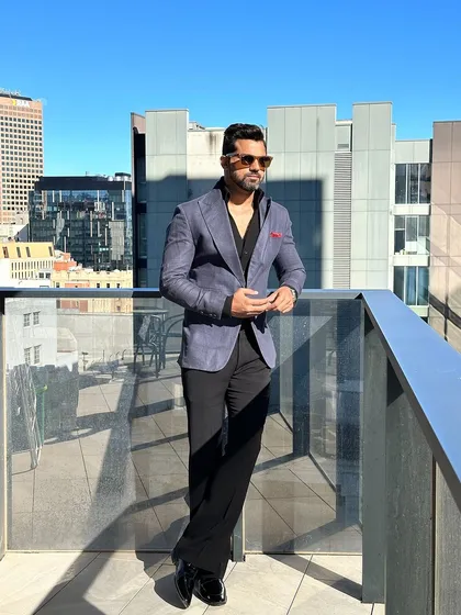 The navy blue blazer against a city skyline, showcasing its urban-chic appeal.