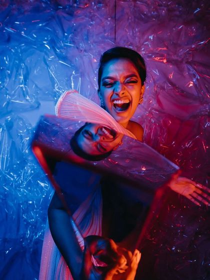 Fun and crazy props are a must for an after-party. This shot captures the energy of our Avant-Garde themed party, with a guest holding a geometric mirror pillar against a backdrop of tinted cellophane.