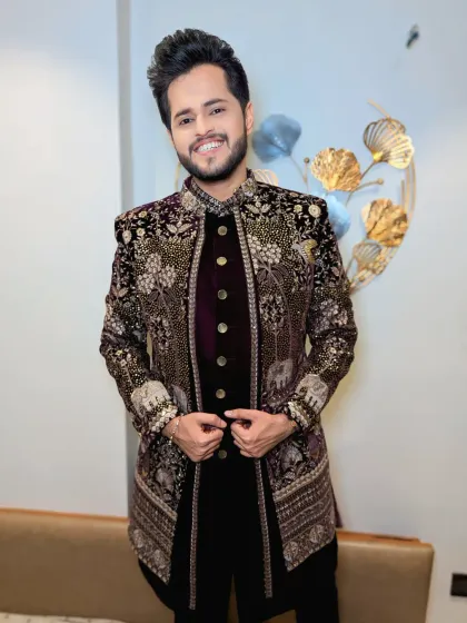 This groom looks absolutely regal in his velvet sherwani. The detailed embroidery with elephant motifs adds a unique traditional touch.