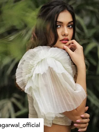 Another beautiful portrait of Divya Agarwal in our custom white blouse. The ruffled sleeve adds a touch of high-fashion elegance, making it a standout piece for any occasion.