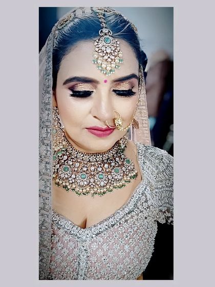 A detailed shot of the eye makeup for this bridal look. The glittery lids and sharp winged liner add a touch of modern glam, while the overall look remains elegant and bridal.