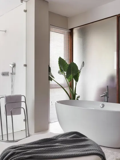 We see bathrooms as complete suites for relaxation. In our 'A Walk in the Clouds' villa, we transformed the primary bath into a luxurious retreat. By removing the old built-in tub, we made space for this elegant freestanding bathtub, creating a spa-like atmosphere that invites you to unwind.