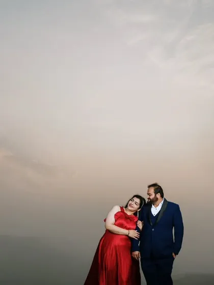 A sweet and simple portrait of a couple enjoying a quiet moment during their outdoor pre-wedding session. The hazy sky and minimalist background keep the focus on their interaction.