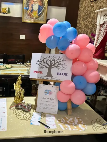 A fun gender reveal game station I set up for a baby shower. The 'Pink or Blue' tree and voting cards add an interactive and exciting element to the party.