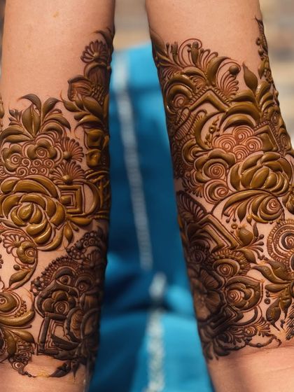 The 3D effect of this design is incredible. The way the patterns are layered and shaded makes the flowers and leaves seem to lift off the skin.