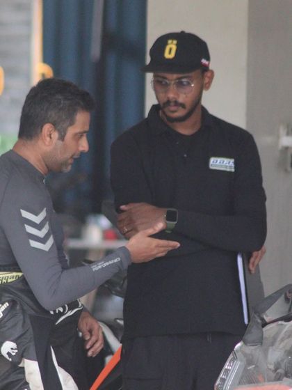 An instructor provides feedback to a rider between sessions. This continuous loop of practice and analysis is how skills are built.