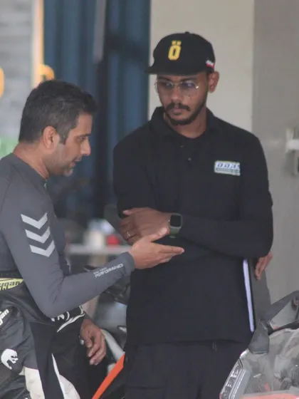 An instructor provides feedback to a rider between sessions. This continuous loop of practice and analysis is how skills are built.