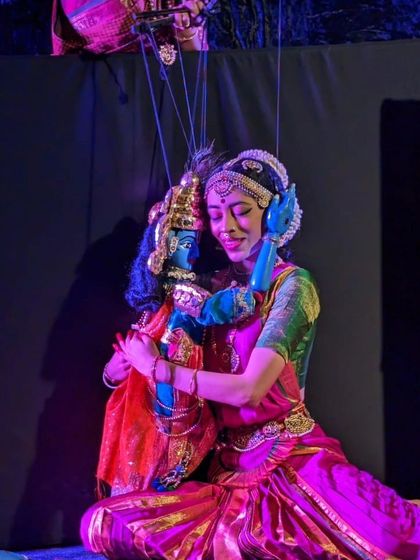 A puppeteer and a puppet share an embrace in a poignant scene from 'Poetry in Puppetry'. This image captures the deep emotional connection that defines our performances.