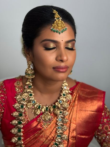 A close-up of Abi's eye makeup. The golden shimmer on her lids and the sharp winged liner make her eyes the focal point of this glamorous traditional look.