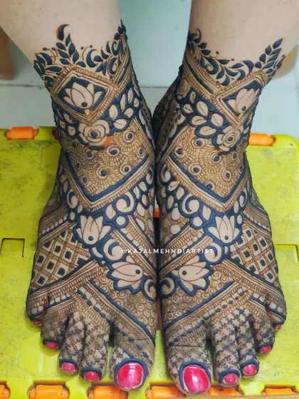 A heavy and intricate design for bridal feet, featuring bold lines, lotus flowers, and detailed checkerboard patterns.