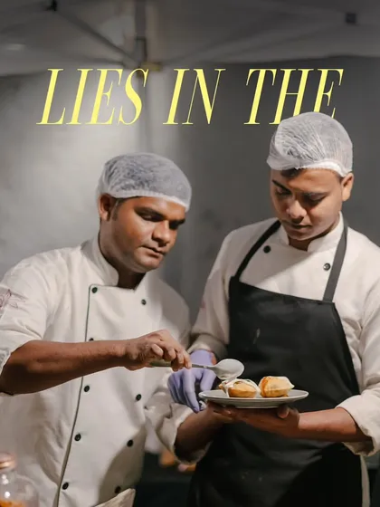 Teamwork makes the dream work. Two of my chefs are collaborating on the final plating of a dessert, ensuring it's perfect before it gets to your table.