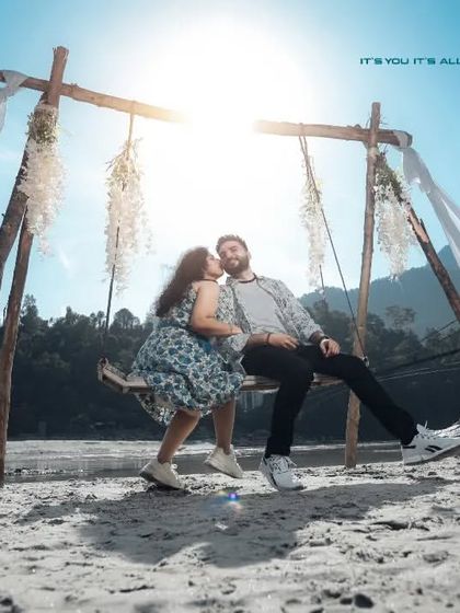 A beautiful shot of the couple on a swing set up on the banks of the Ganga. The backlighting from the sun creates a dreamy, romantic glow.