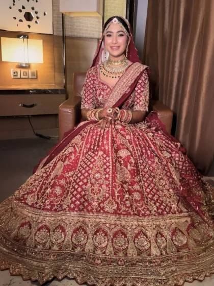 Seated like a queen, this bride's intricate lehenga is on full display. Her makeup is subtle yet transformative, designed to last all day and look stunning in every photo.