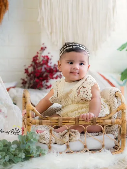 A happy baby girl enjoying her milestone session. Her sweet smile and the beautiful bohemian decor create a perfect picture.