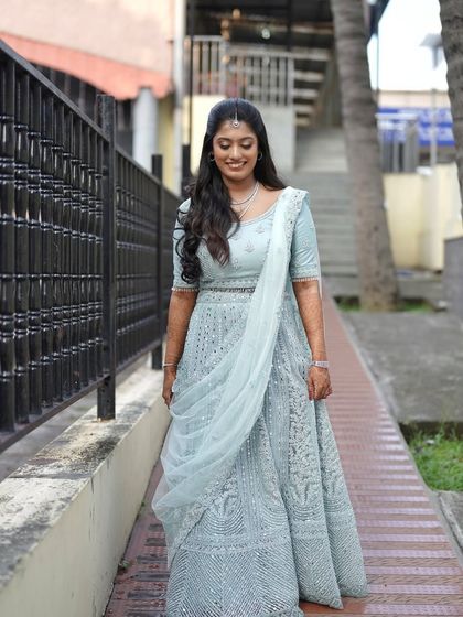 This bride's reception lehenga was a beautiful pastel blue. I created a soft, romantic makeup look with loose curls to complement the delicate color and intricate embroidery of her outfit.