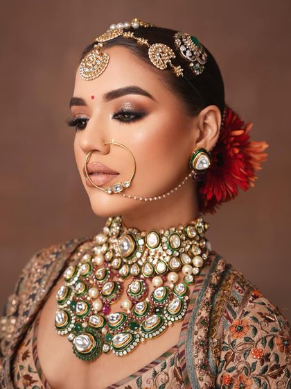 A detailed close-up of the eye makeup and the magnificent nath.