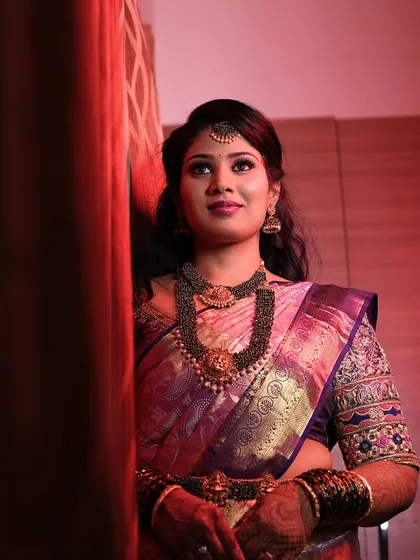 The bride looking up, showcasing her beautiful eye makeup and jewellery.