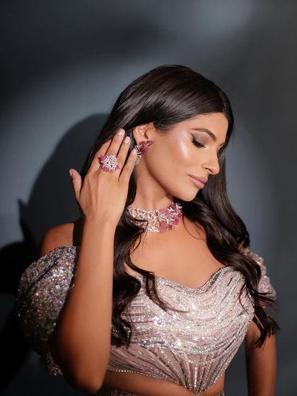 Every angle matters. This side profile showcases the delicate makeup application, from the soft eyeshadow blend to the perfectly sculpted cheekbones, complementing the intricate jewelry and hairstyle.