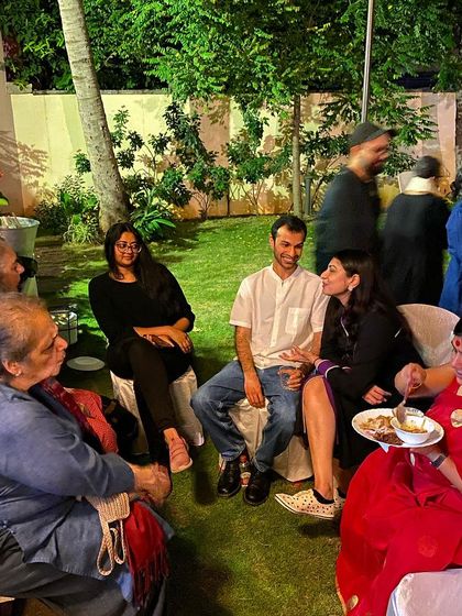 Guests chatting in the garden during the dinner party.