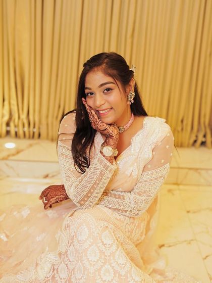 A client looking sweet and elegant in a white chikankari style lehenga.