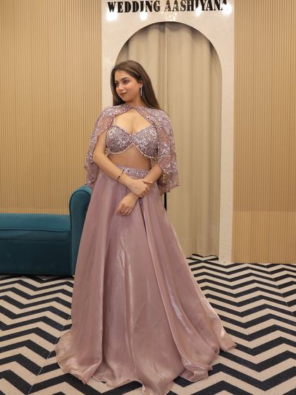 The bridesmaid's edition. This mauve organza lehenga with a stunning embellished cape blouse is a luxurious yet affordable rental option for the bride's tribe.
