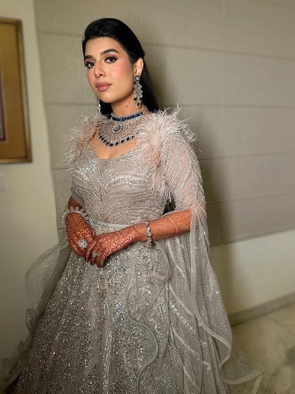 Another angle of this glamorous reception look, highlighting the flawless skin and the way the makeup catches the light.