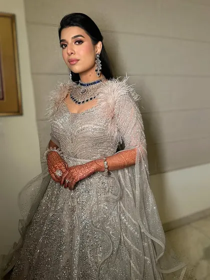 Another angle of this glamorous reception look, highlighting the flawless skin and the way the makeup catches the light.