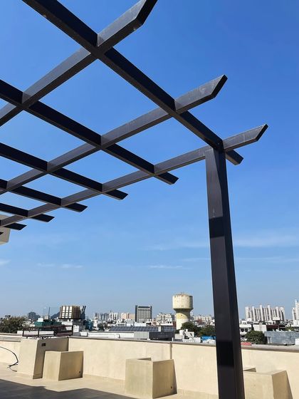 A close-up of the metal rafter pergola structure. This demonstrates the clean joinery and sturdy construction that forms the backbone of the final, fully-outfitted terrace garden.