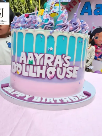 A close-up of the custom-designed Gabby's Dollhouse cake, perfectly matching the party's theme and colour scheme.