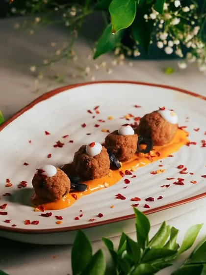Plated with red chili flakes for an extra kick, these Chipotle Chicken Meatballs are a modern and exciting addition to any catering menu.