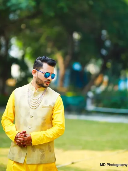 Another cool shot of the groom at his Haldi. My grooming service ensures you look your best, even in candid moments.
